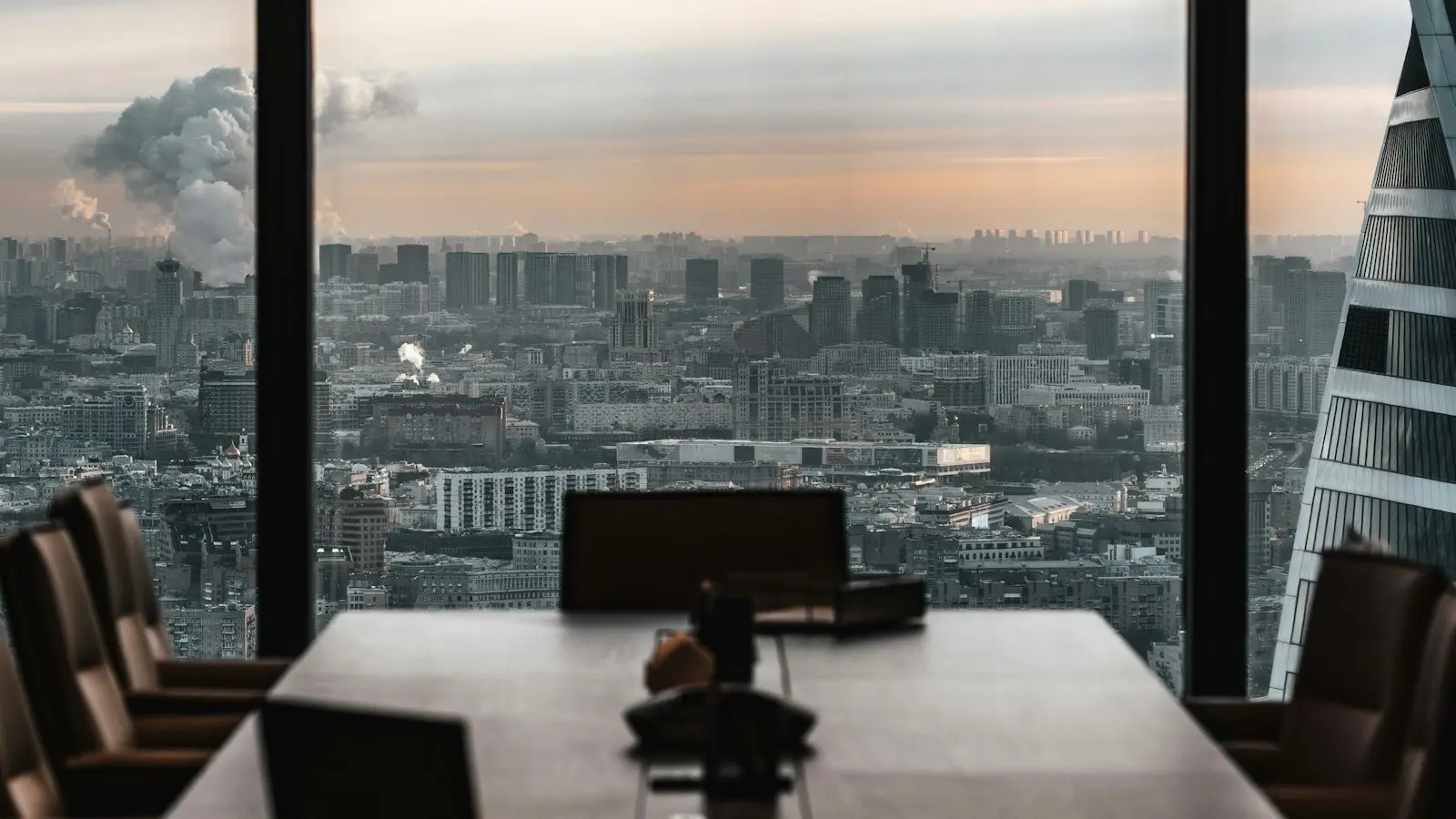 Empty boardroom overlooking a city skyline